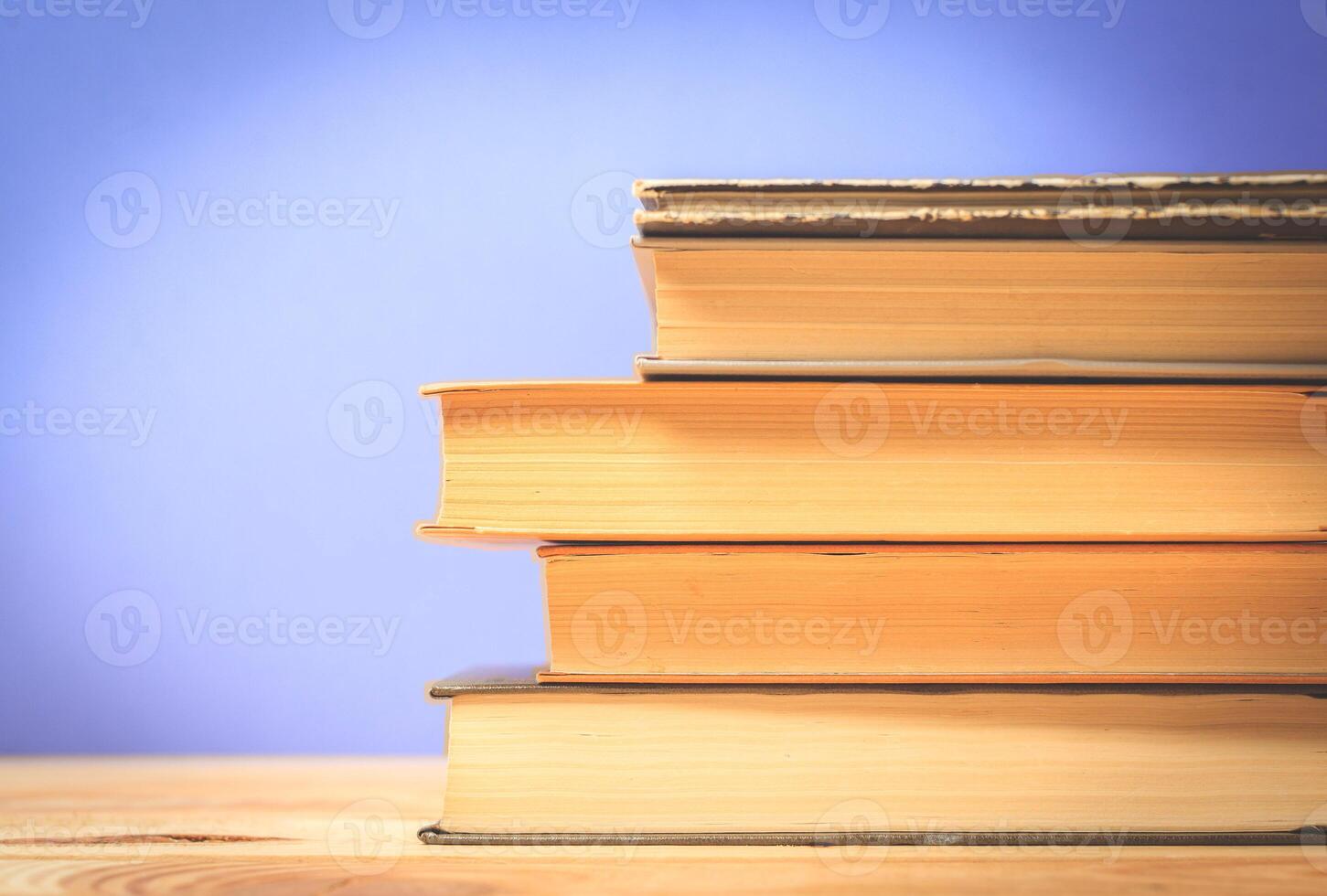 Vintage old books on wooden deck table photo