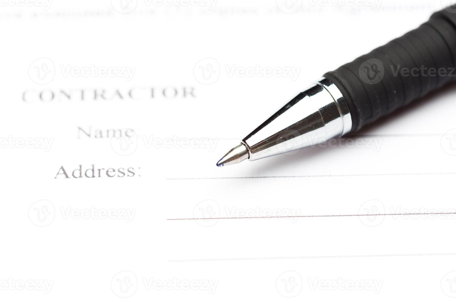 Close-up of pen on contract photo