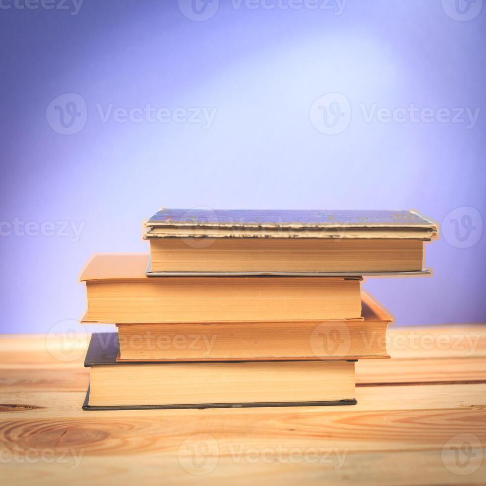 Vintage old books on wooden deck table photo