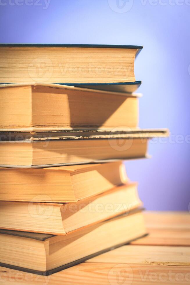 Vintage old books on wooden deck table photo