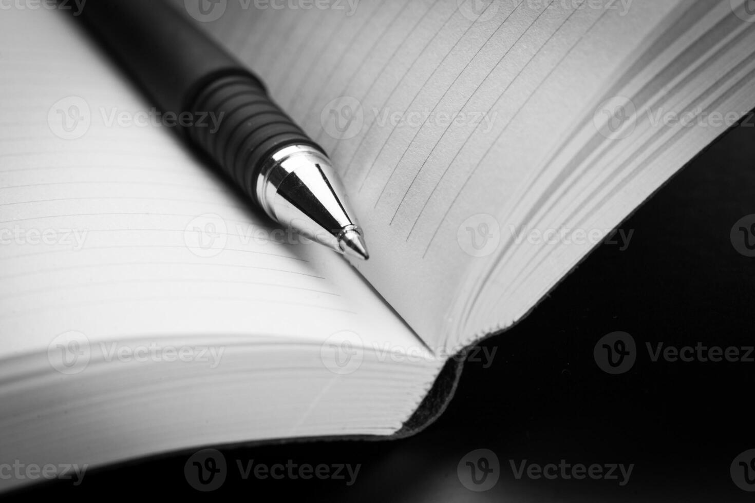 blank notebook and pen on the table photo