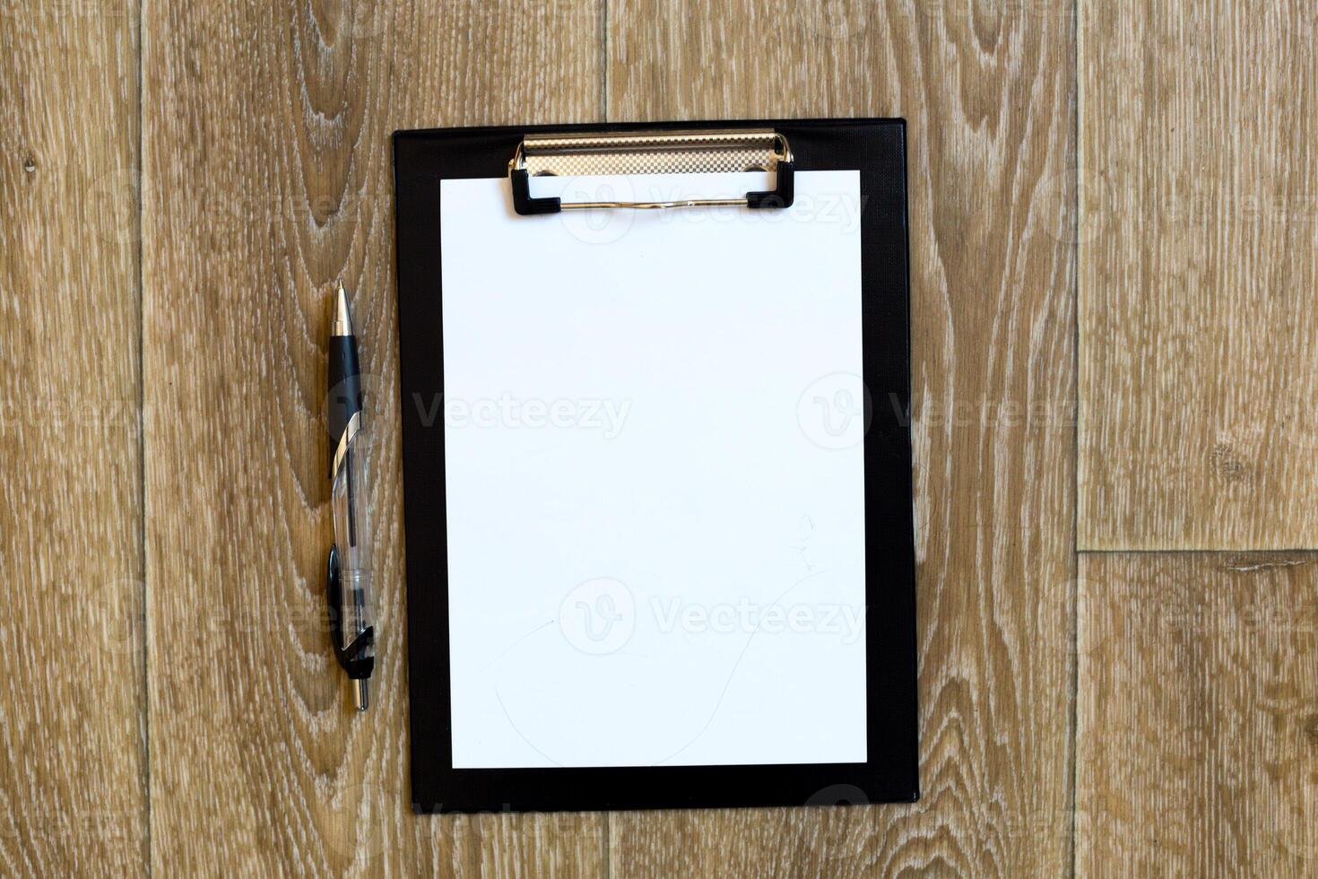 Pen and Notepad on the wooden desk photo