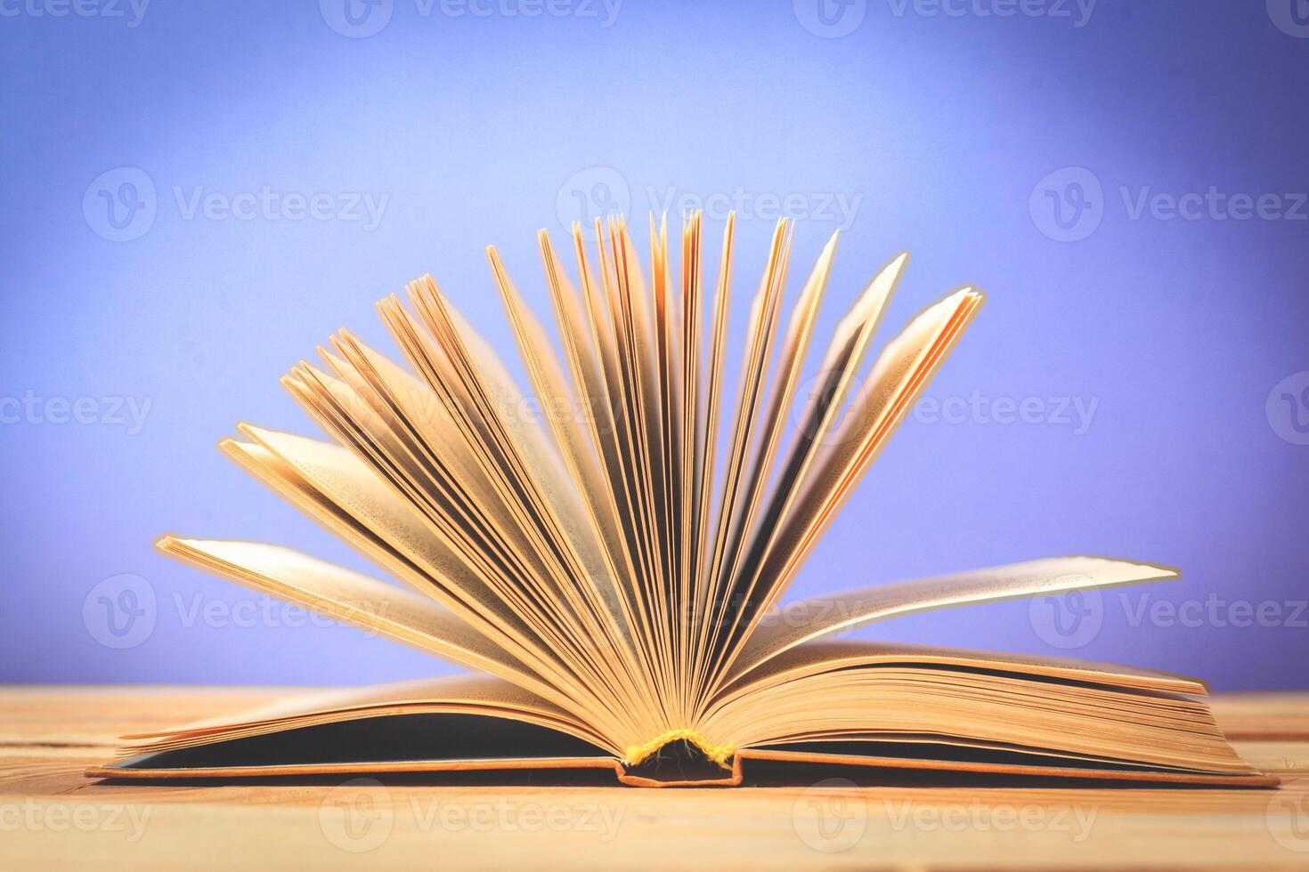 Vintage old books on wooden deck table photo