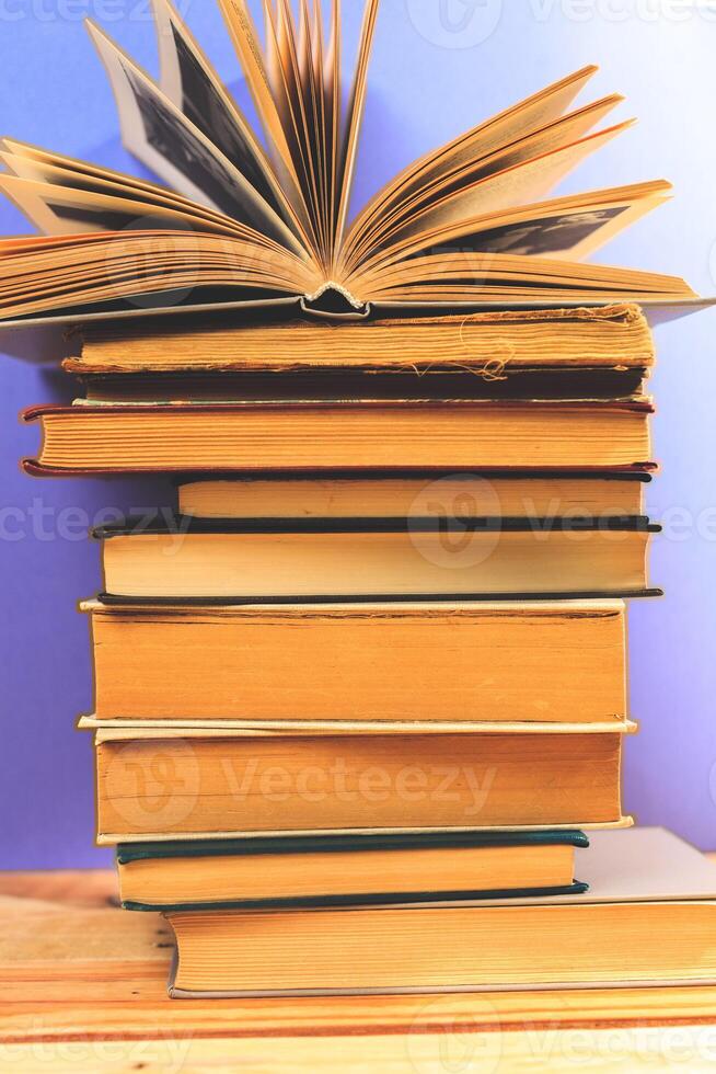Vintage old books on wooden deck table photo