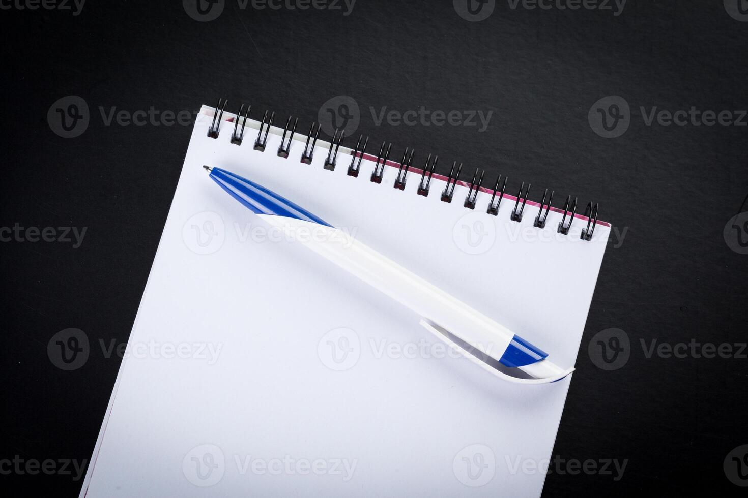 blank notebook and pen on the table photo