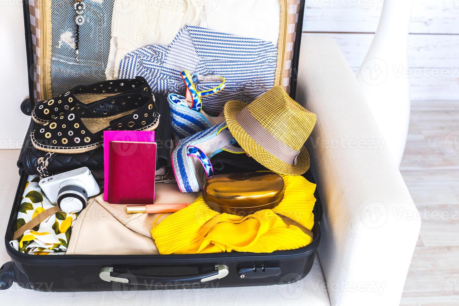 Packed suitcase of vacation items photo