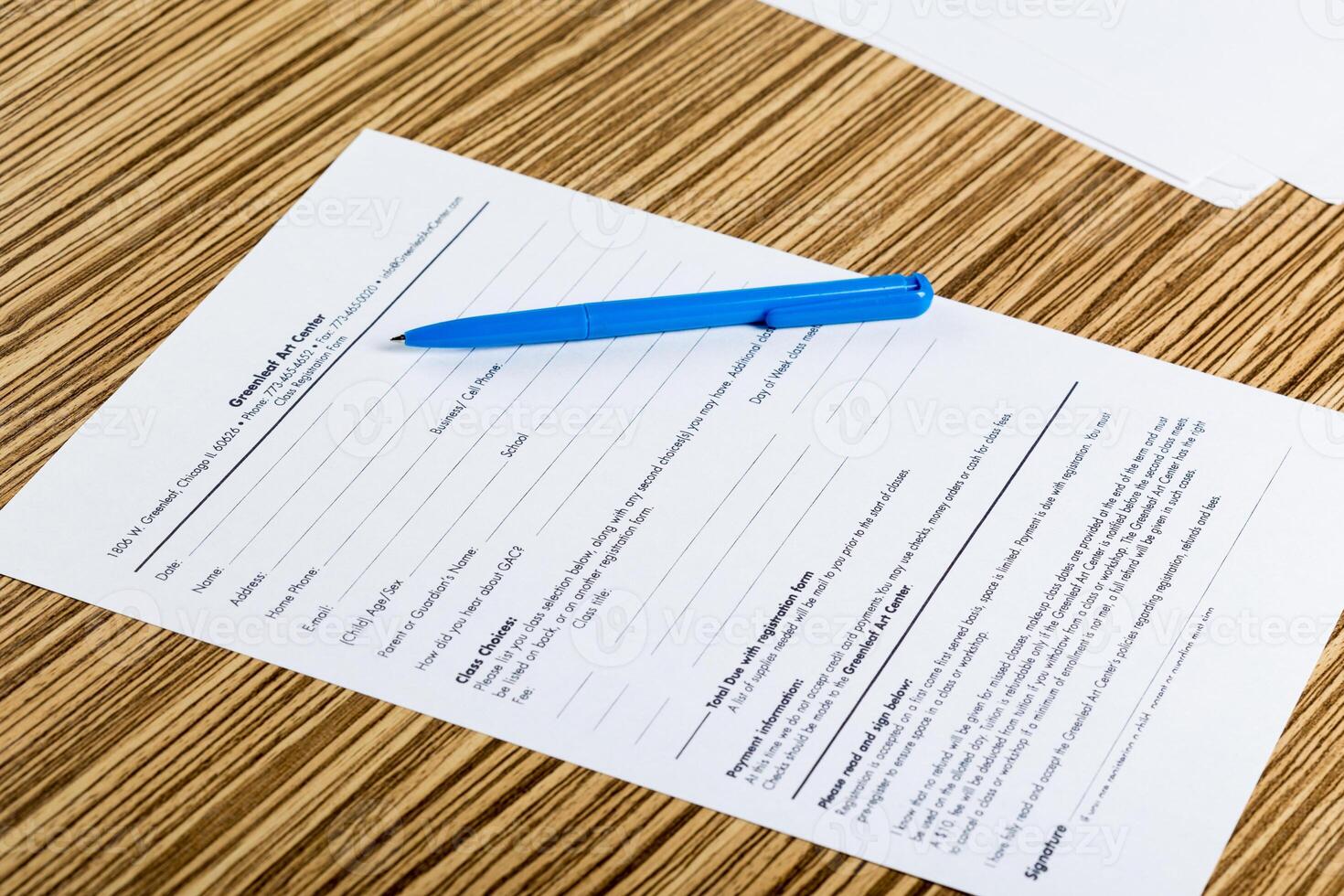 Pen and contract papers on wooden desk photo