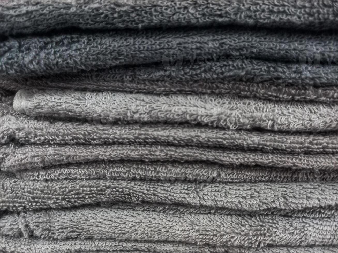 A stack of clean, soft towels in monochrome colors photo