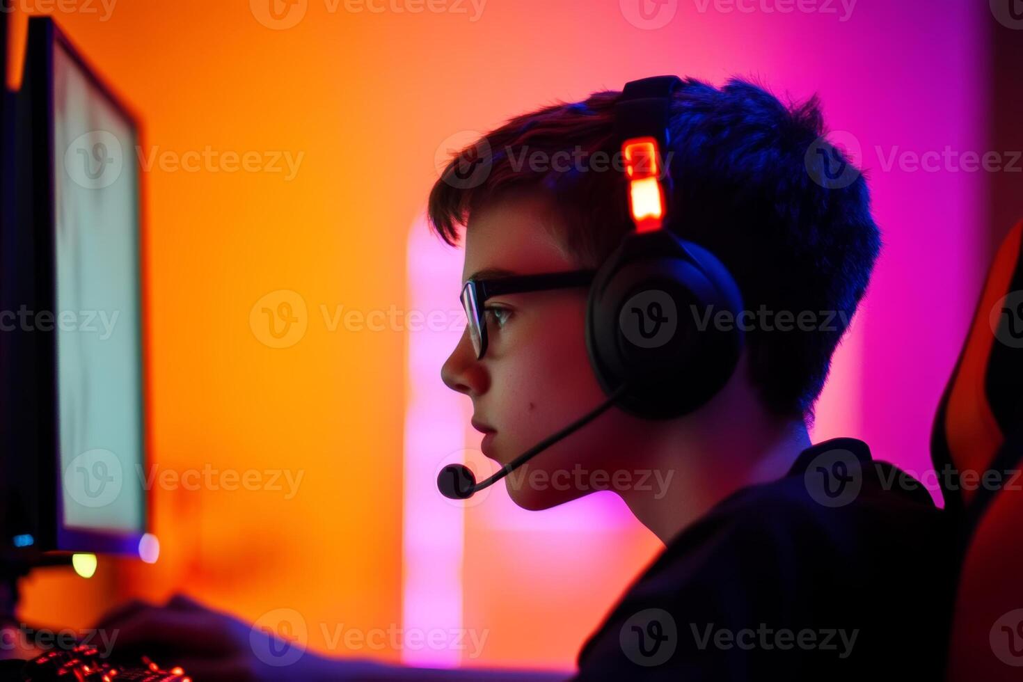 A young gamer immersed in gameplay during an evening session with vibrant lighting effects in a cozy gaming setup photo