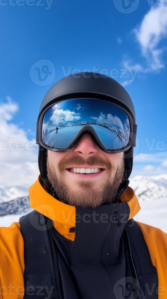 A smiling skier takes a selfie on a sunny day in the snowy mountains, showcasing clear blue skies and breathtaking scenery photo