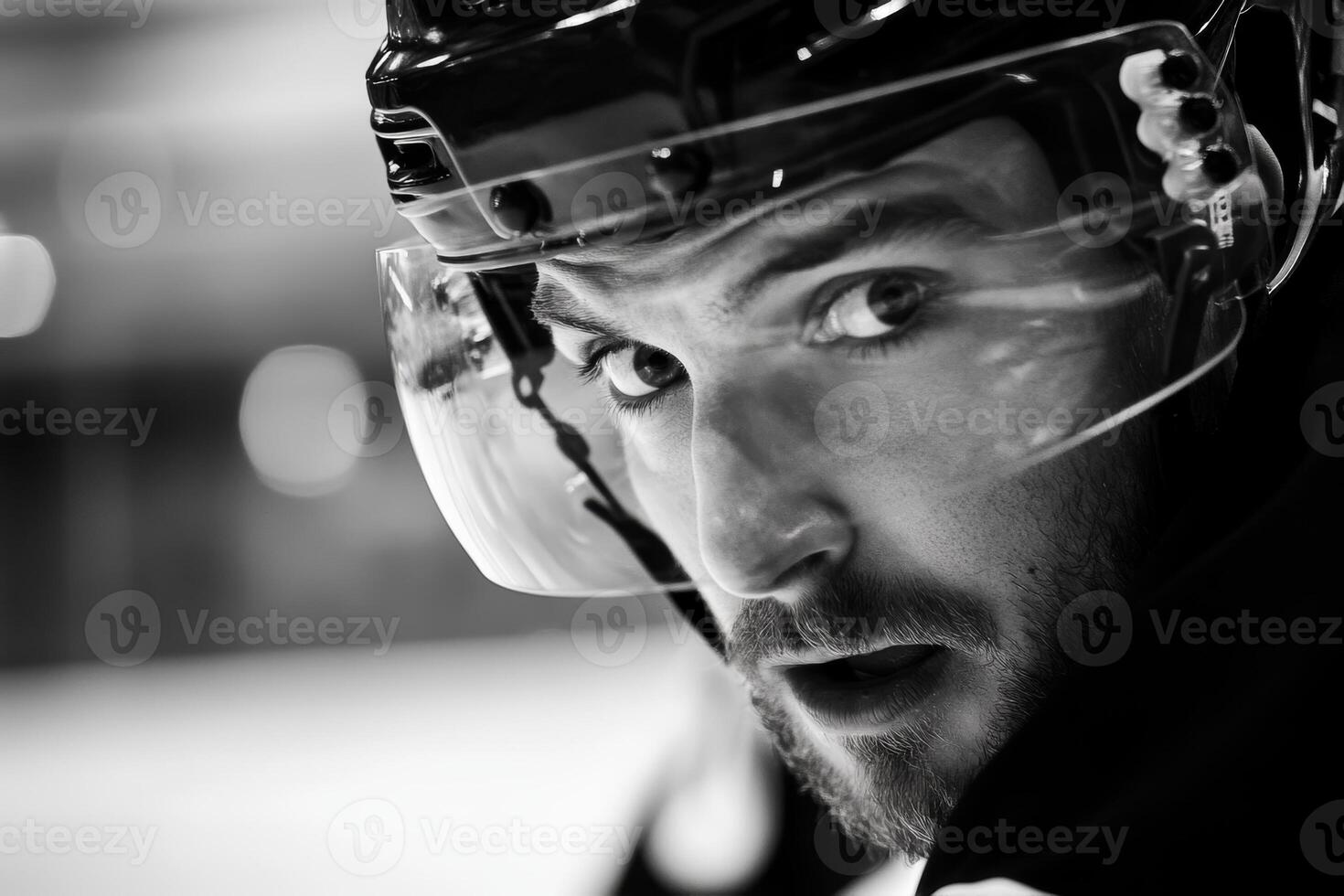 Intense hockey player focuses on the game while wearing a helmet during a match at a local ice rink in winter photo