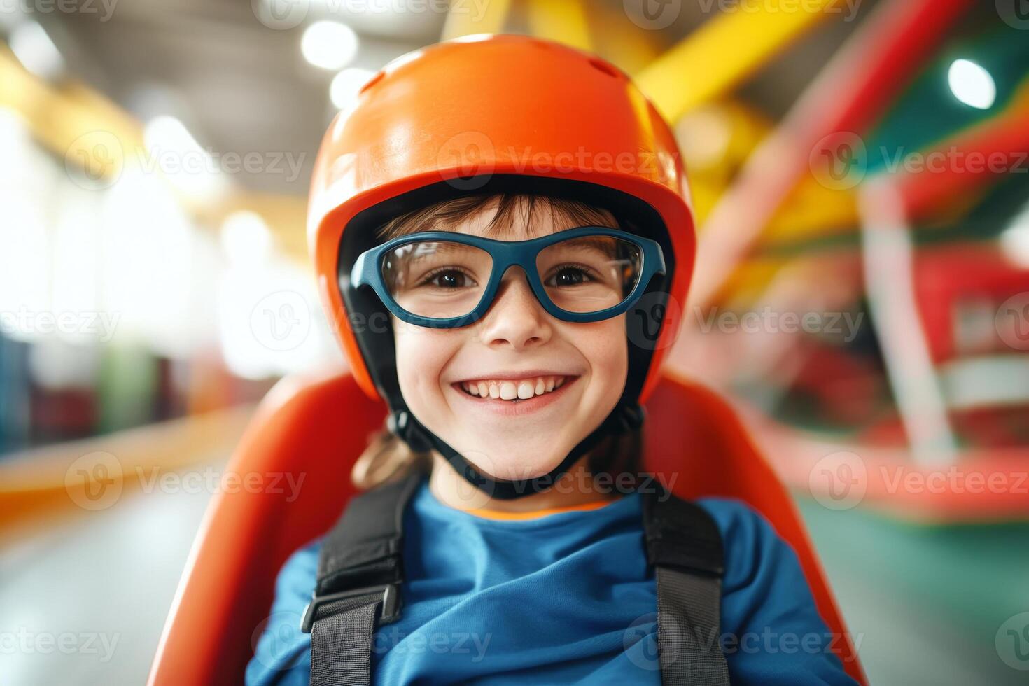 A joyful child prepares for an exciting ride in a colorful indoor amusement park during the daytime photo
