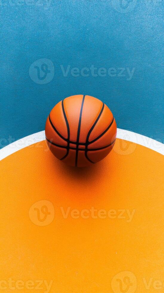 A vibrant basketball rests on a colorful court surface , awaiting the next thrilling game photo