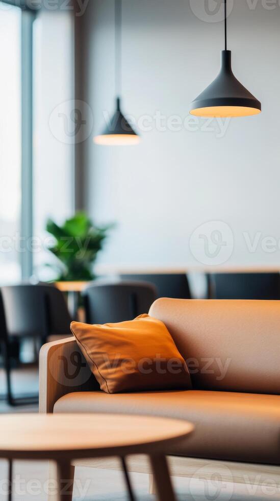 Modern seating area with ambiance lighting in a contemporary lounge, featuring a plush sofa and green plants during daylight hours photo