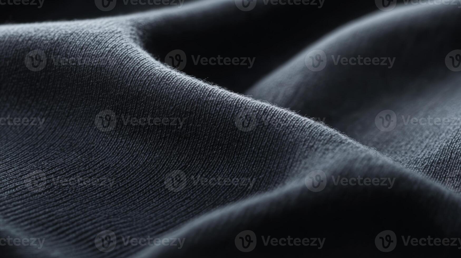Close-up view of soft, dark fabric showcasing texture and folds in a well-lit indoor photo