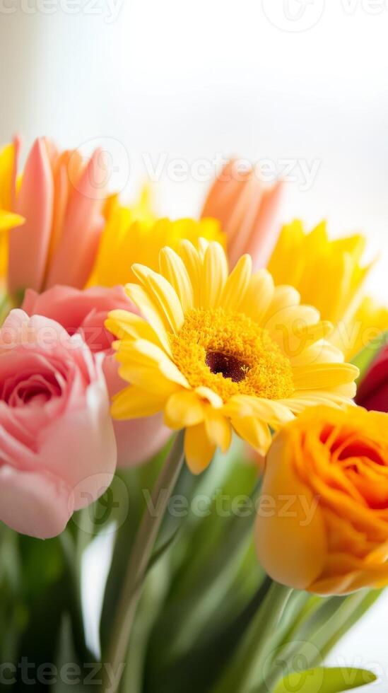 A vibrant bouquet of colorful flowers including tulips, roses, and gerberas arranged for a cheerful spring display indoors photo