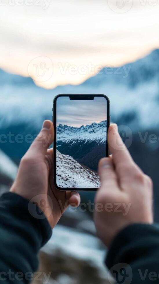 Capturing breathtaking mountain views with a smartphone at sunset in a snowy landscape photo