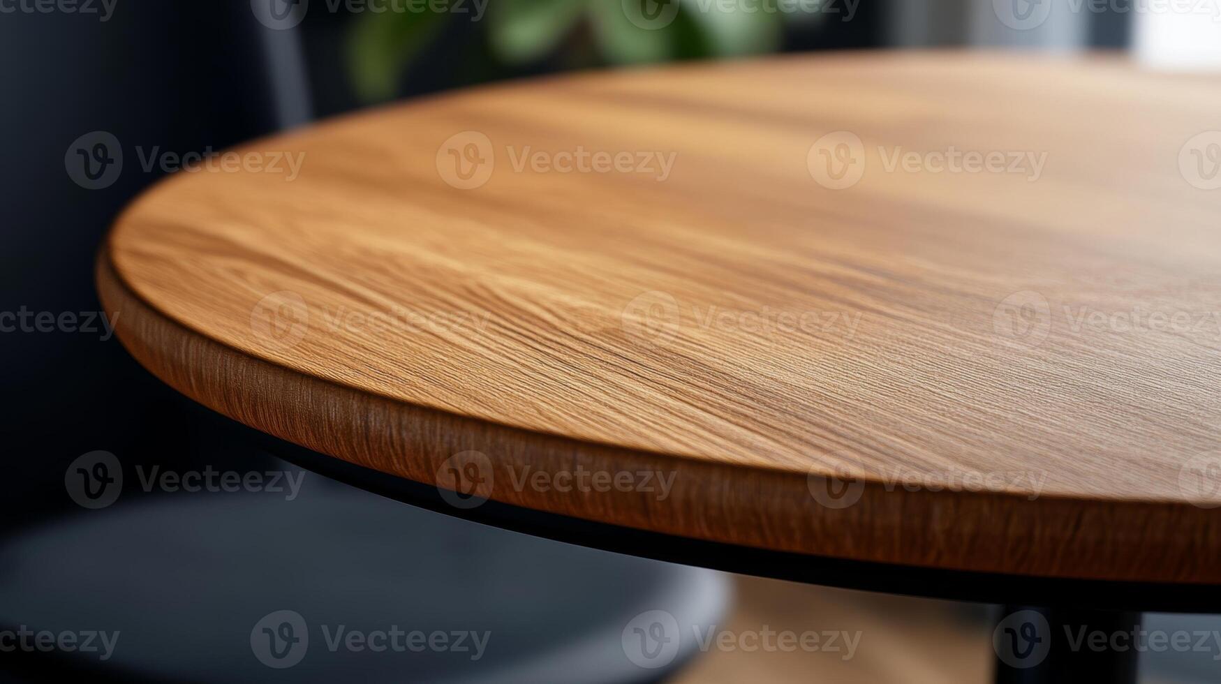 Close-up view of a round wooden table showcasing natural grain patterns in a modern indoor setting photo