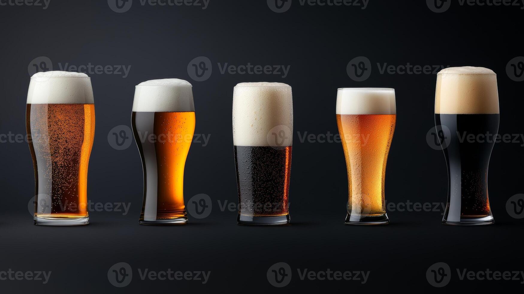 A variety of beers in glasses showcasing different colors and foam styles against a dark background photo