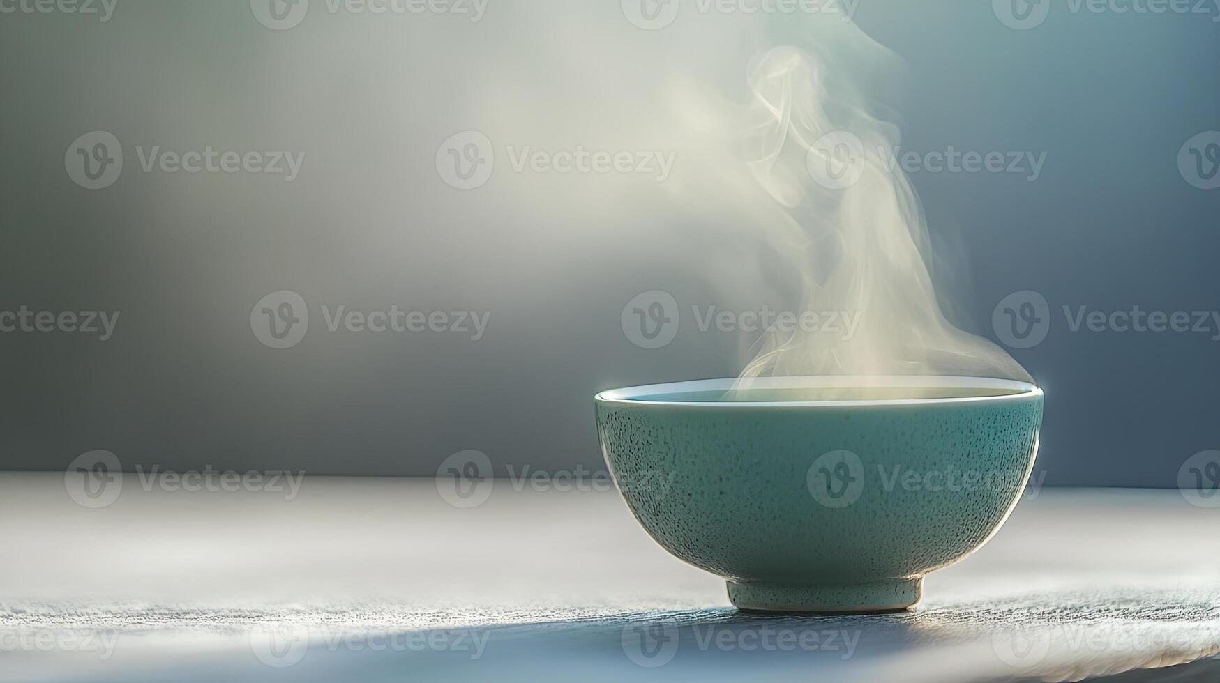 A Delicate Teal Bowl of Steaming Hot Soup photo