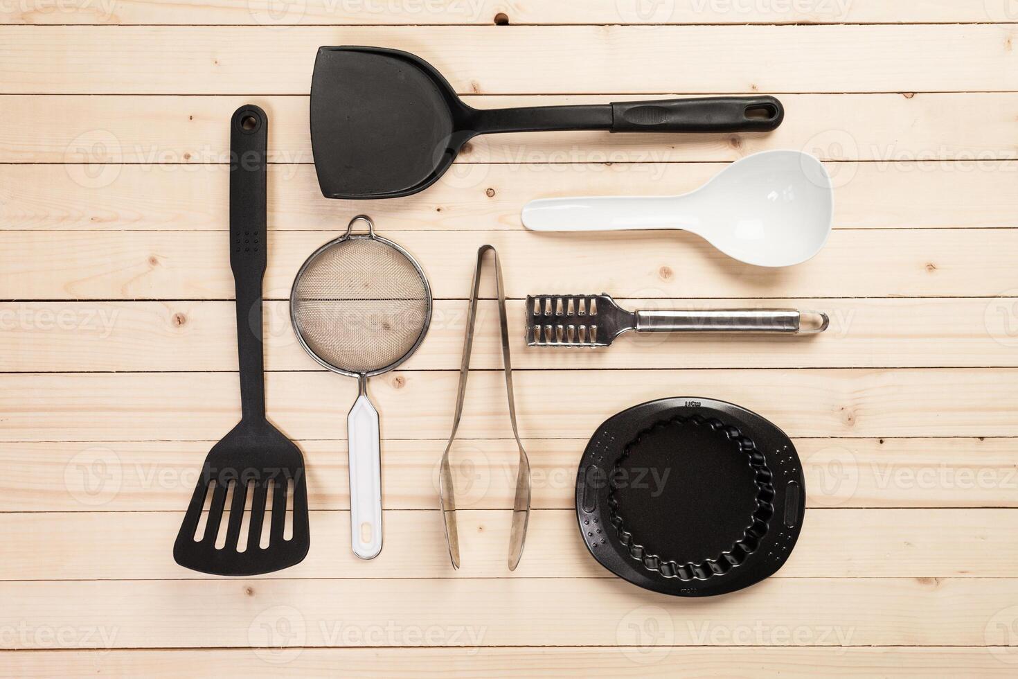 cookware and accessories on a wooden table. photo