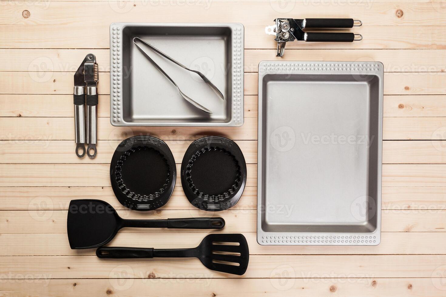 cookware and accessories on a wooden table. photo