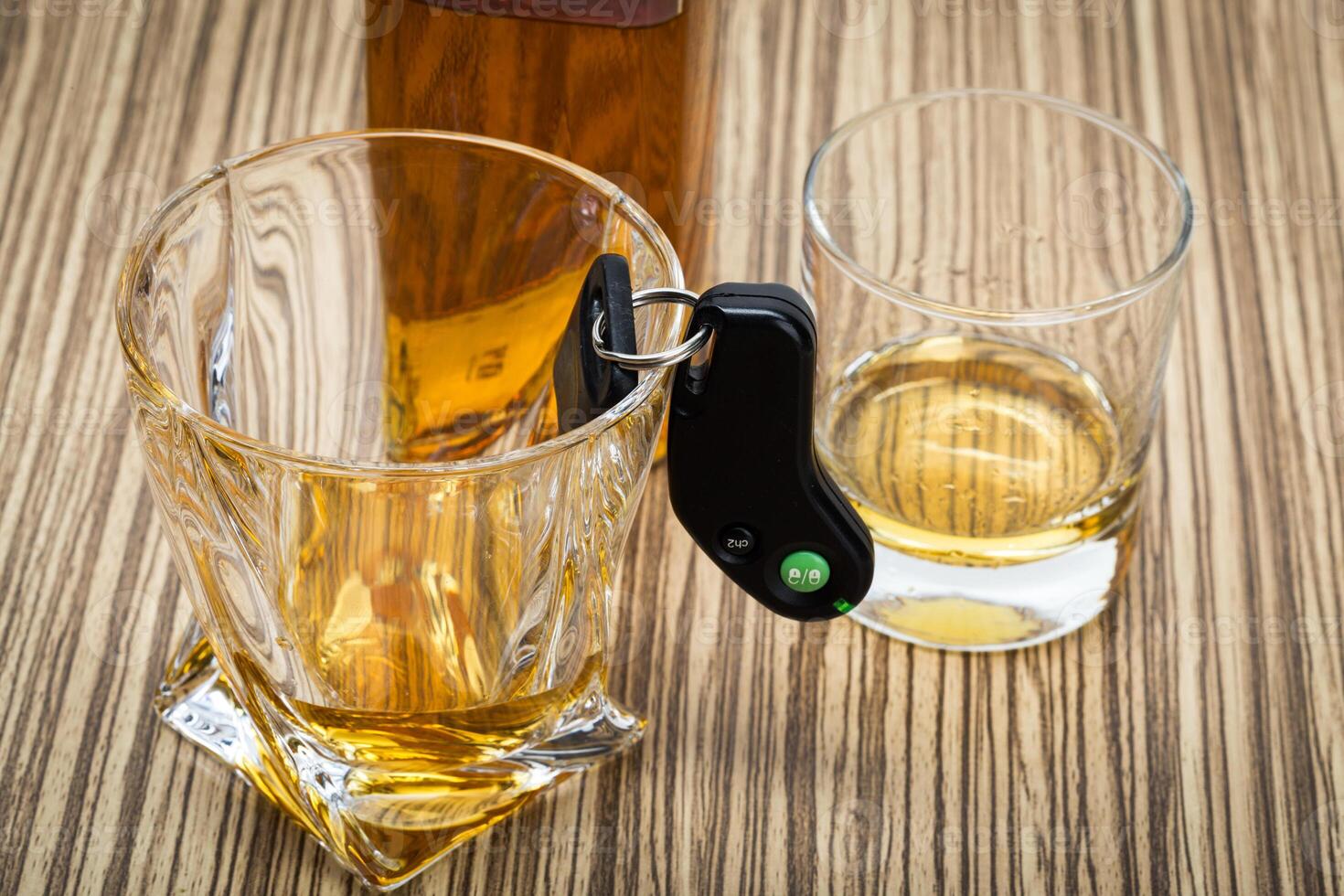 Car key on the bar with spilled alcohol photo