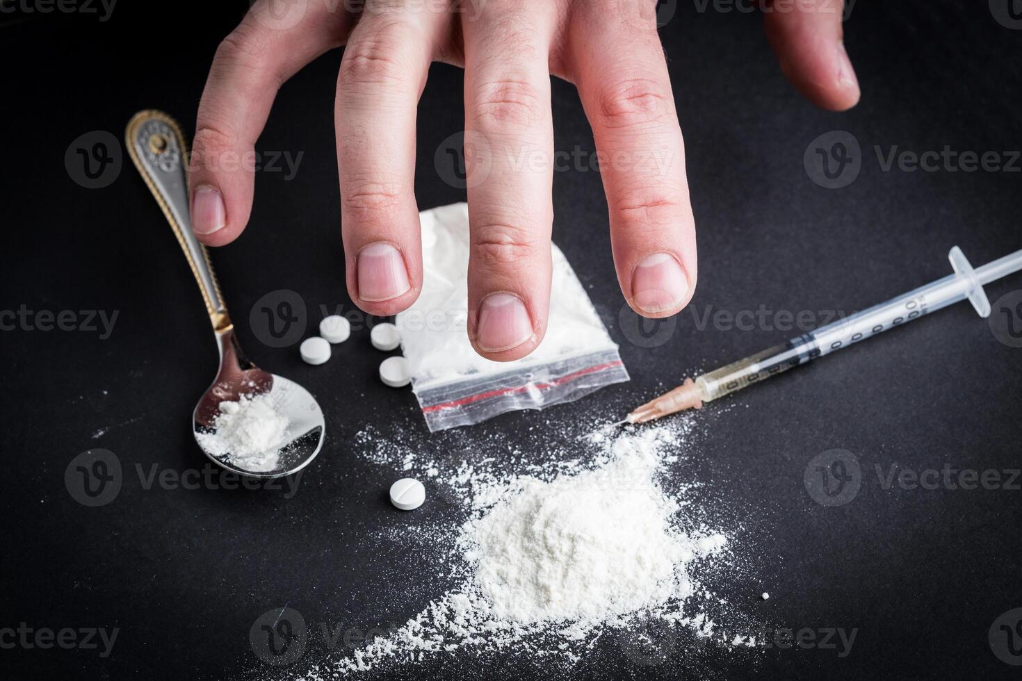 Dirty hand grabbing narcotics photo