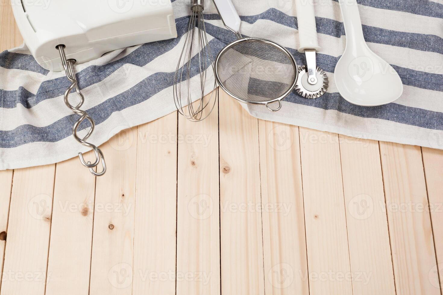 Various kitchen utensils on wooden table photo