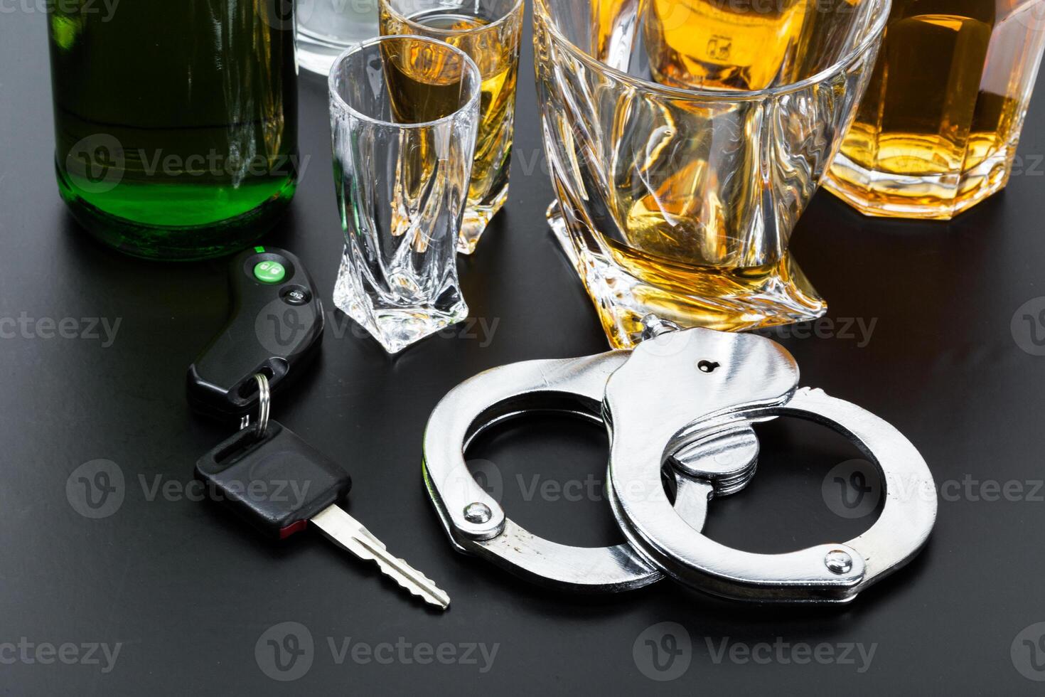 Car key on the bar with spilled alcohol photo