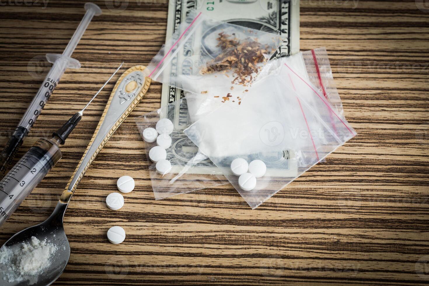 Drug syringe and cooked heroin on spoon photo