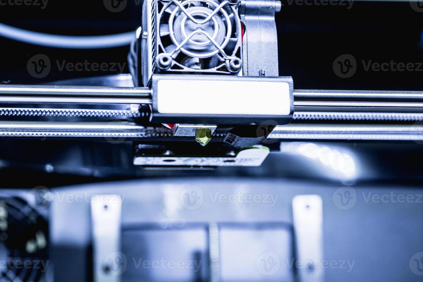 head of 3d printer in action photo