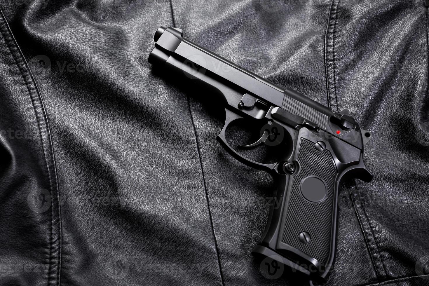 Rifle, gun, knife with sheath, compass and notebook with pen on on black cloth photo