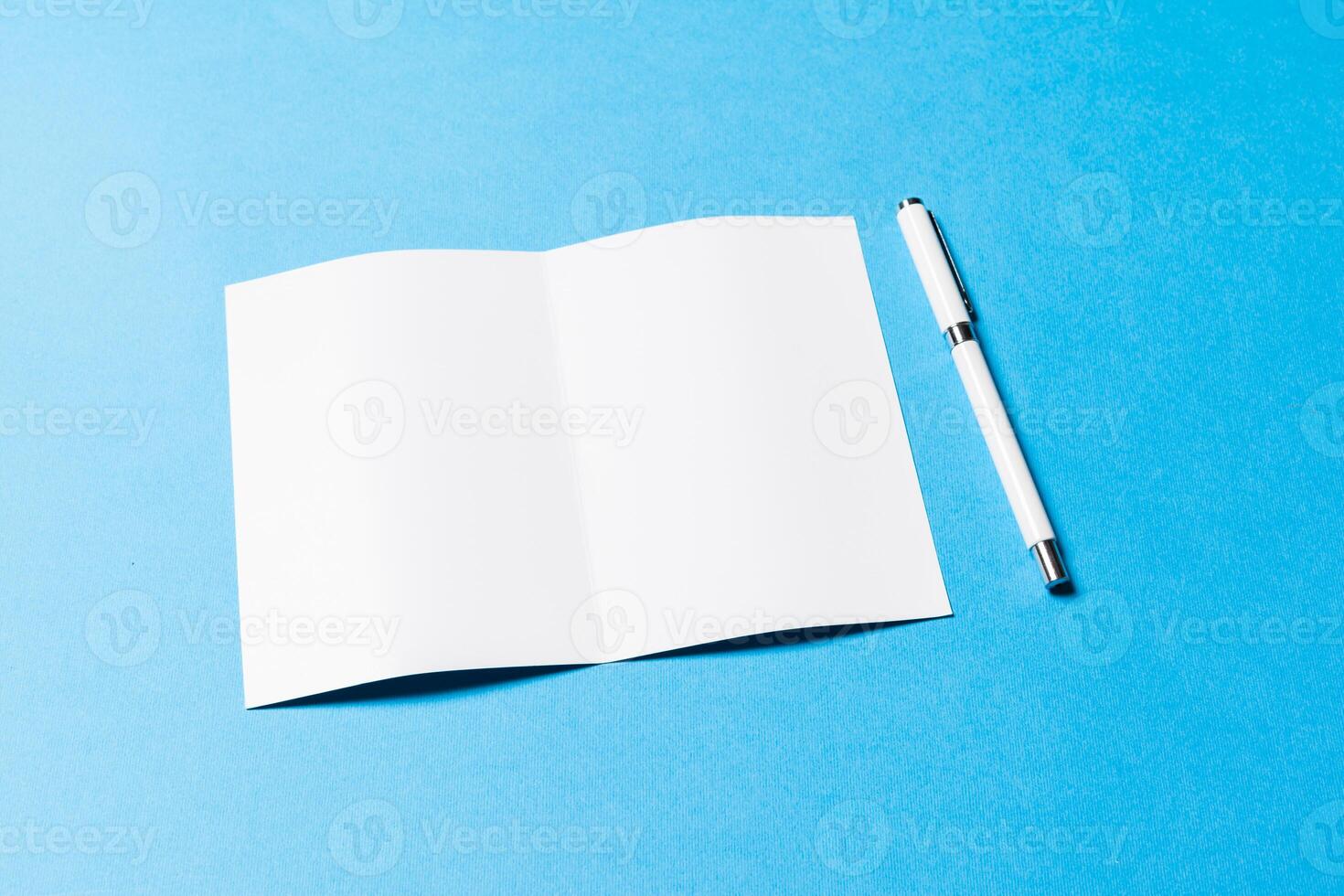 blank office objects organized for company presentation on blue paper background photo