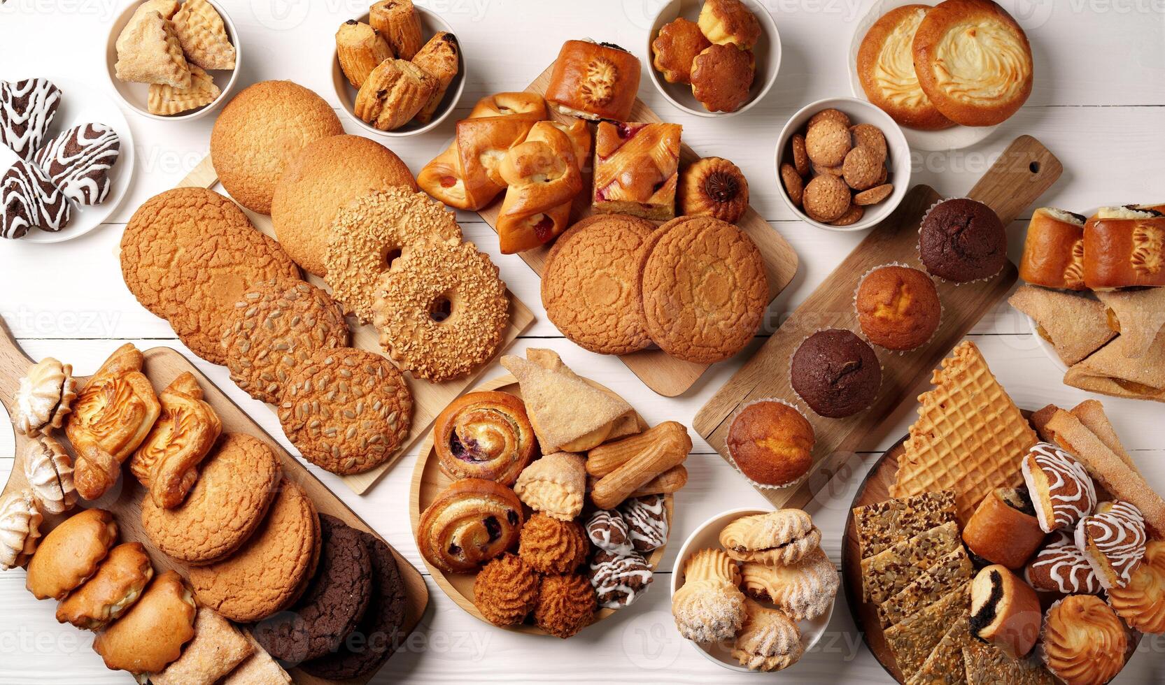 Assortment of baked goods displayed on a wooden surface with various styles and flavors photo