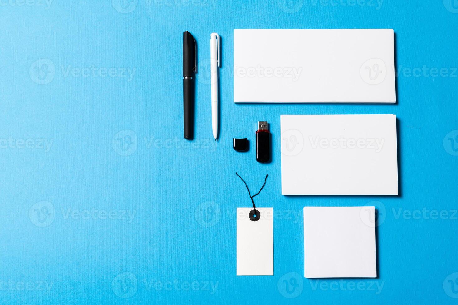 blank office objects organized for company presentation on blue paper background photo