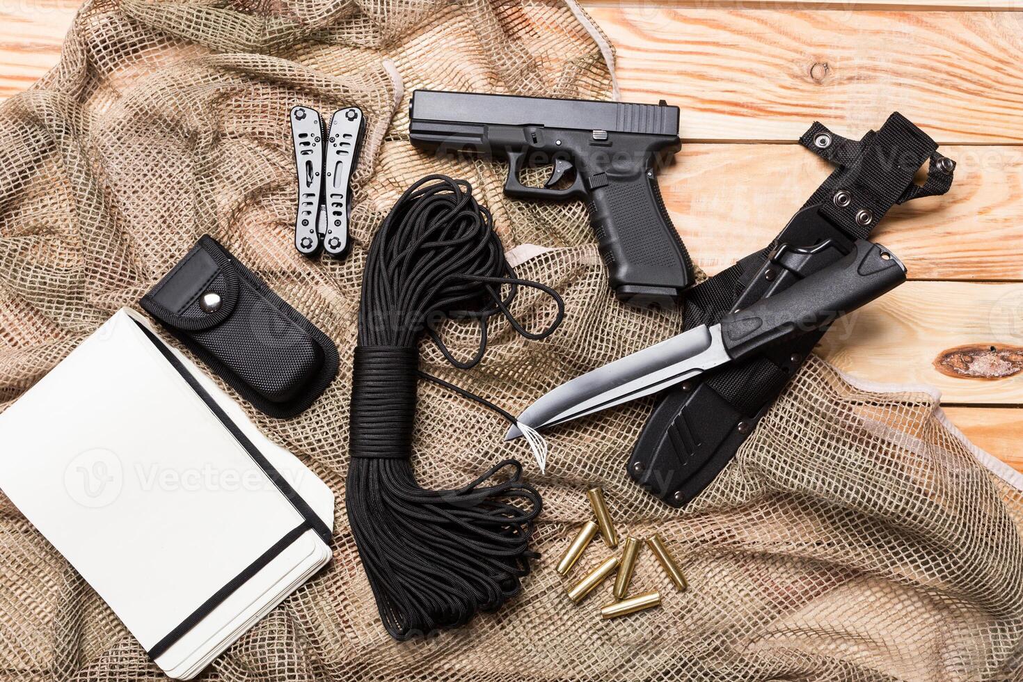 gun, knife with sheath, compass photo