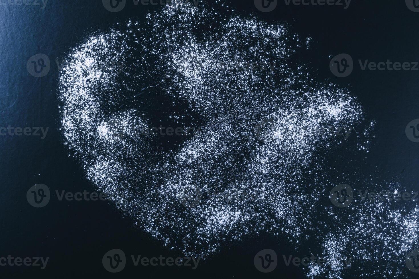 Dark wooden background with flour dust photo
