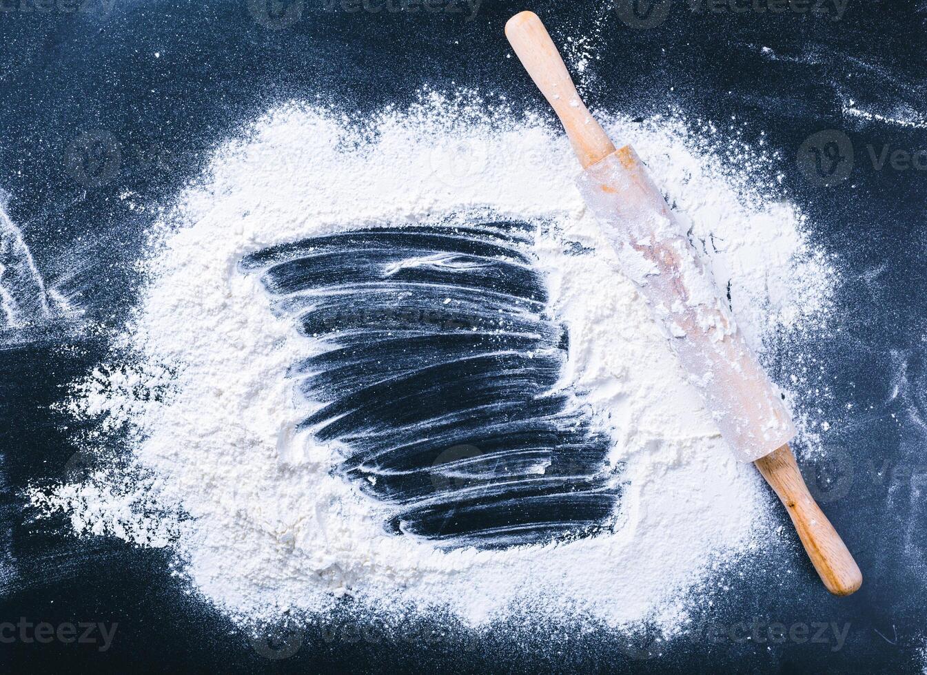 Baking desk with flour and rolling pin, top view photo