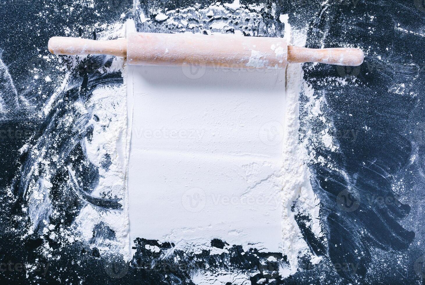 Baking desk with flour and rolling pin, top view photo