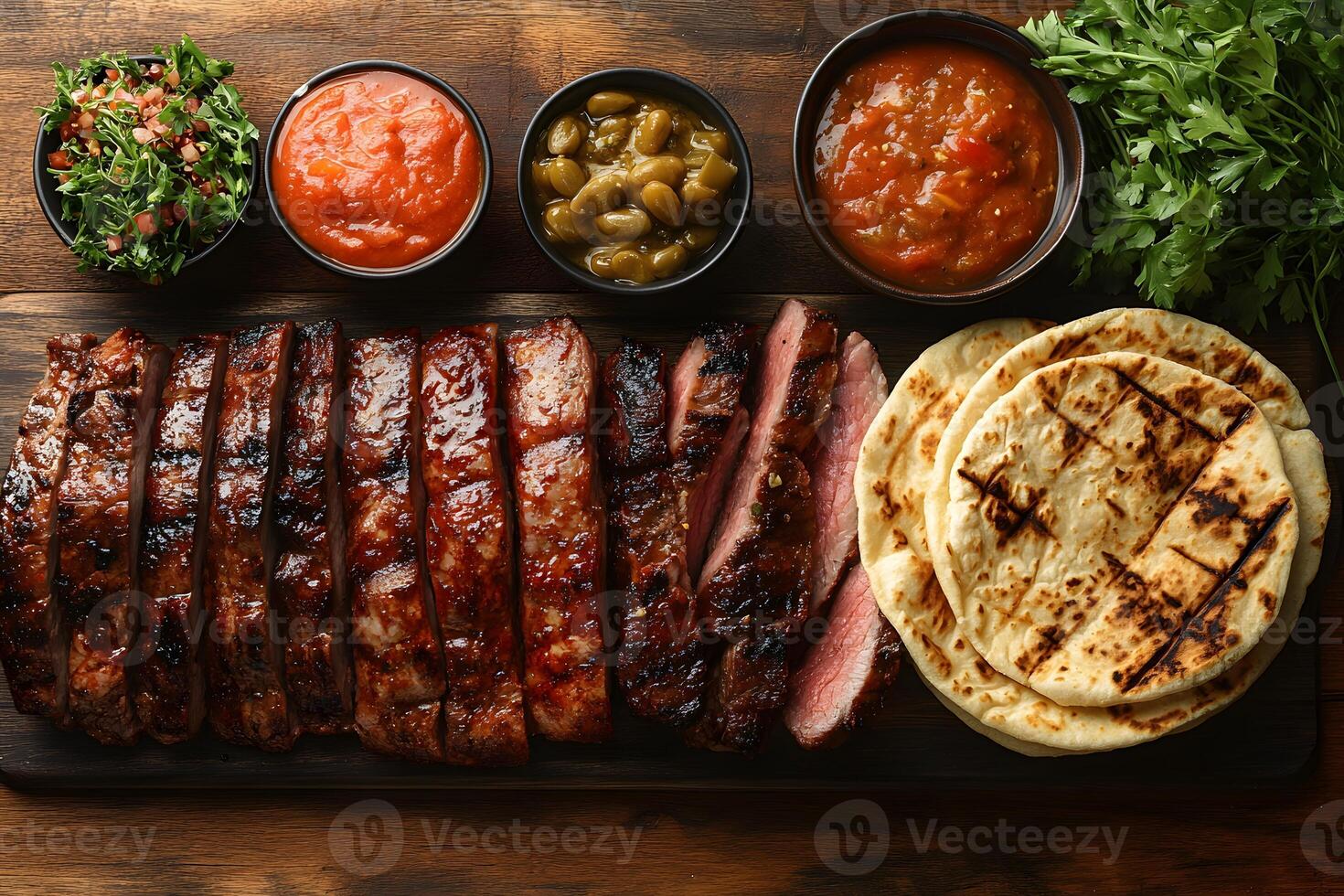 Delicious Barbecue Ribs with Sauces and Grilled Flatbread for Rustic Dining Experience photo