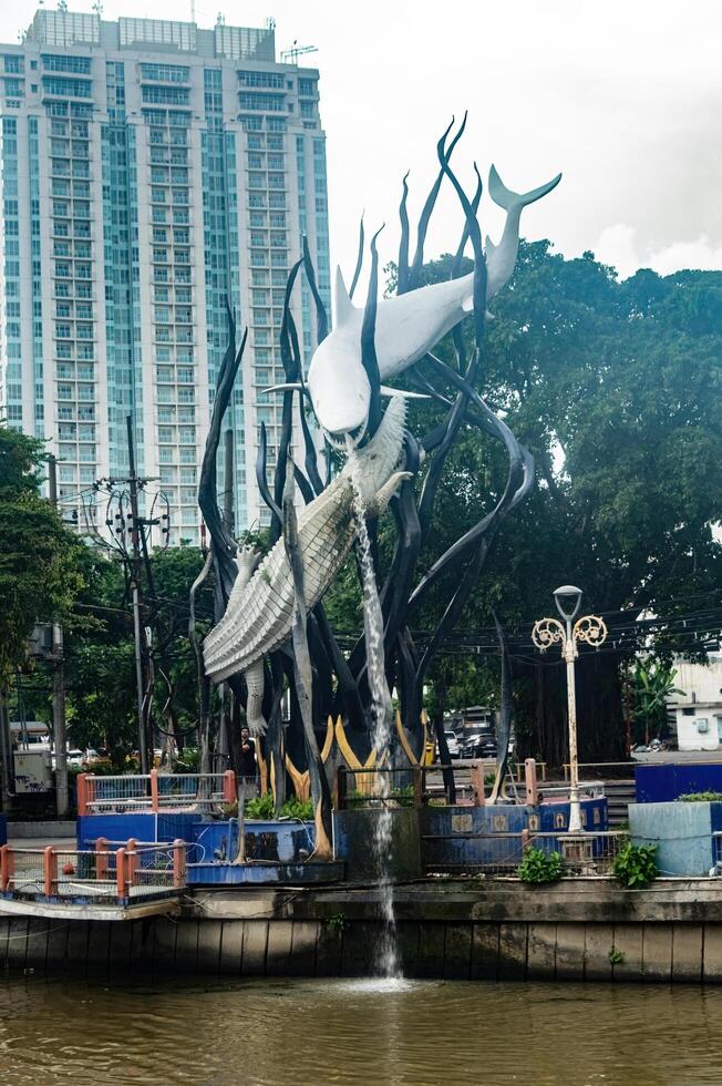 A striking monument in Surabaya featuring a crocodile and a shark intertwined in a dramatic pose, symbolizing the city name and history, Indonesia, 12 January 2025 photo