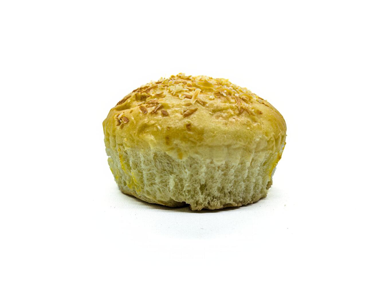 A close up of a freshly baked bread roll topped with shredded cheese, showcasing its golden brown crust and soft, fluffy texture. Perfect for bakery or food related content photo
