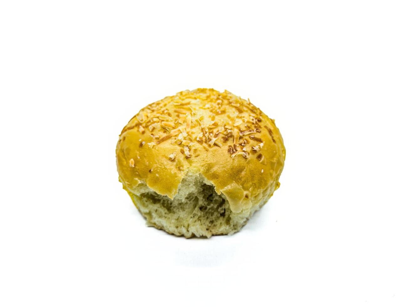 A close up image of a partially eaten sesame seed bun on a white background. The golden brown crust and fluffy interior are clearly visible, making it an appetizing and visually appealing subject photo