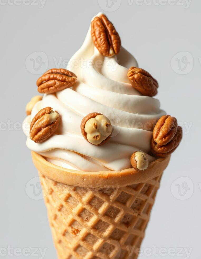 Delicious soft serve ice cream topped with pecans served in a waffle cone photo