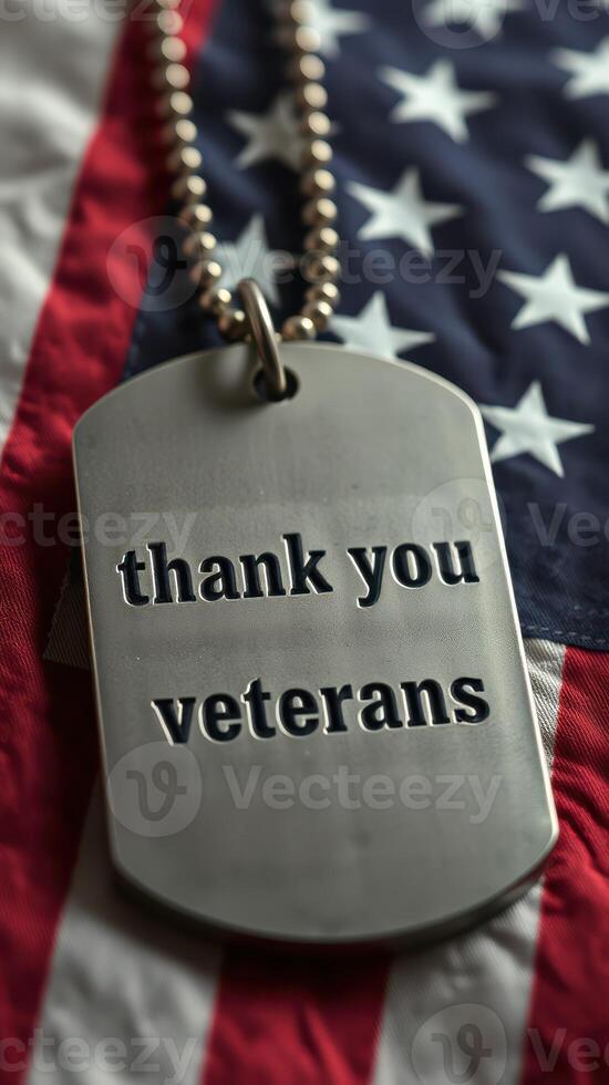 Metal dog tag expresses gratitude to veterans resting on an American flag background, symbolizing honor and respect for military service photo