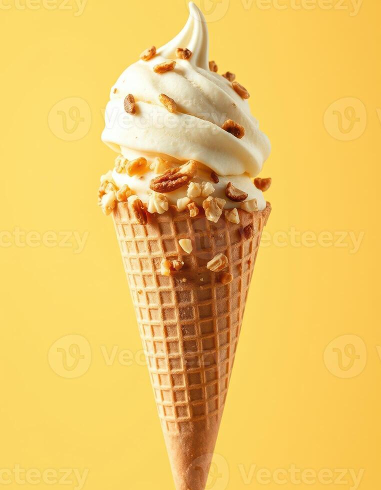 Delicious soft serve ice cream cone topped with crunchy caramel and nuts against a vibrant yellow background photo