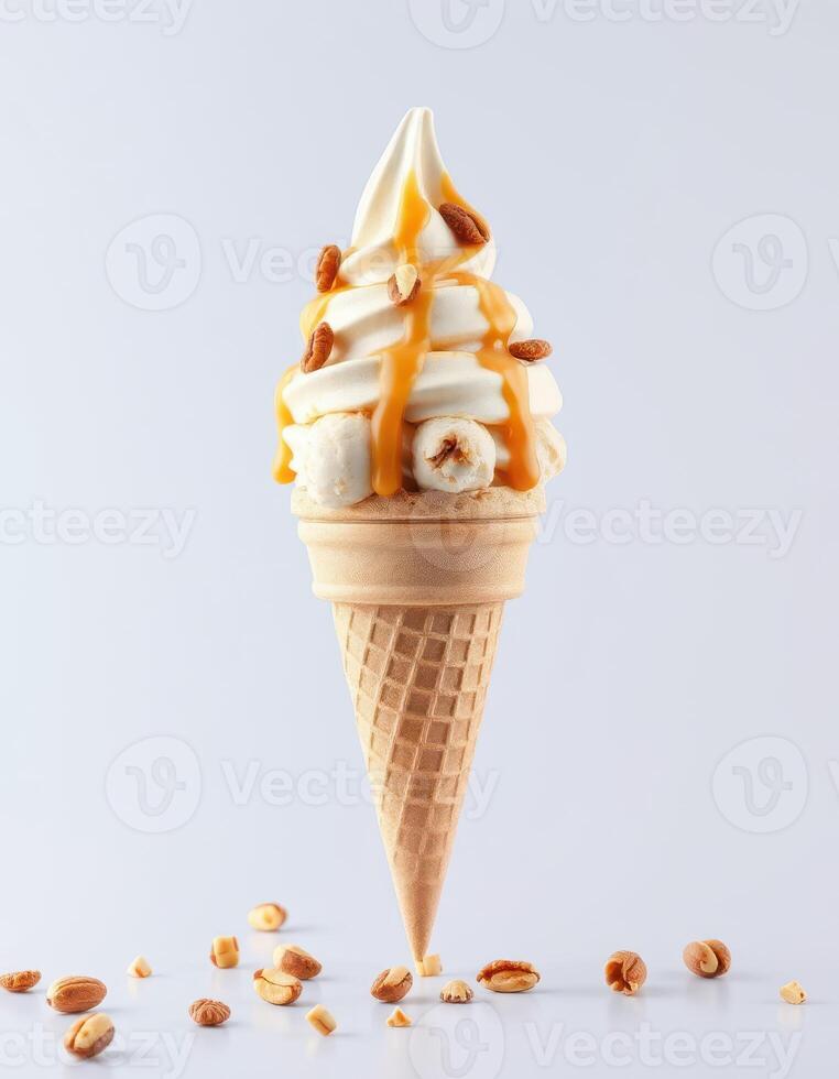 Delicious soft serve ice cream topped with caramel and crushed nuts in a waffle cone photo