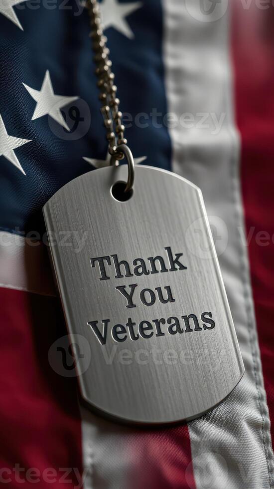 Metal dog tag with Thank You Veterans message displayed on American flag background signifies appreciation for military service photo