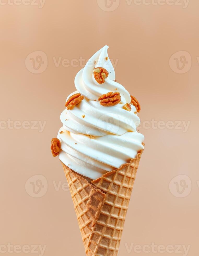 Creamy soft serve ice cream with pecans in a waffle cone against a neutral background photo